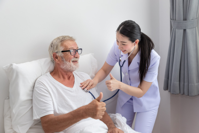 nurse use stethoscope to examine elderly man health in bedroom